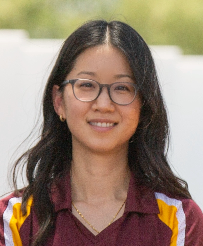 A profile photo of Erin Chiou shows an east asian woman with long dark hair and light skin wearing glasses and a polo shirt in ASU colors, maroon and gold. 